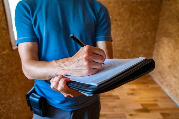 Midsection of man reading book while sitting on table