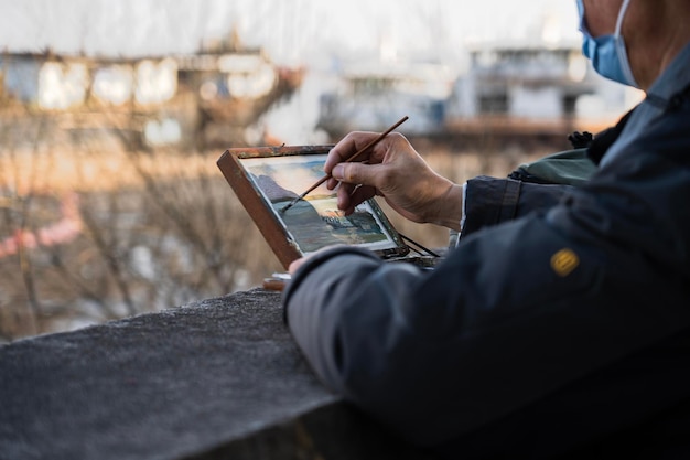 Midsection of man using mobile phone while sitting on table