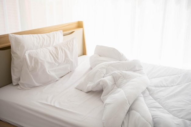 Midsection of messy bed at home