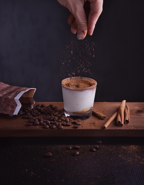 Midsection of person holding coffee cup on table