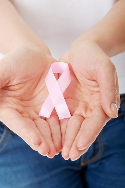 Midsection of woman holding aids awareness ribbon