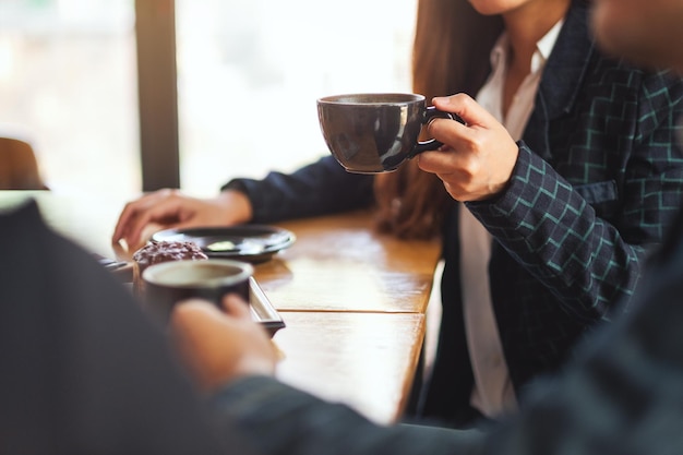 Midsection of woman holding coffee cup