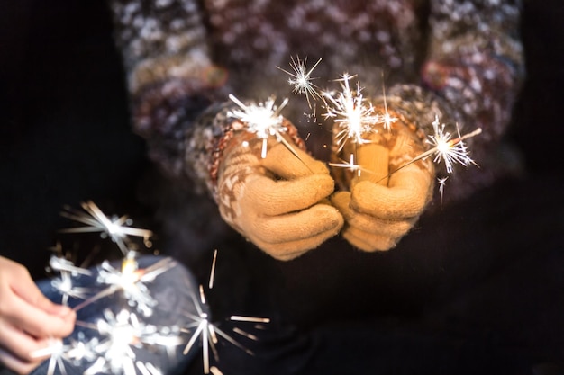 Photo midsection of woman holding sparkler at night