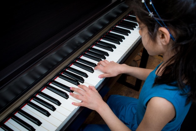 Midsection of woman playing piano