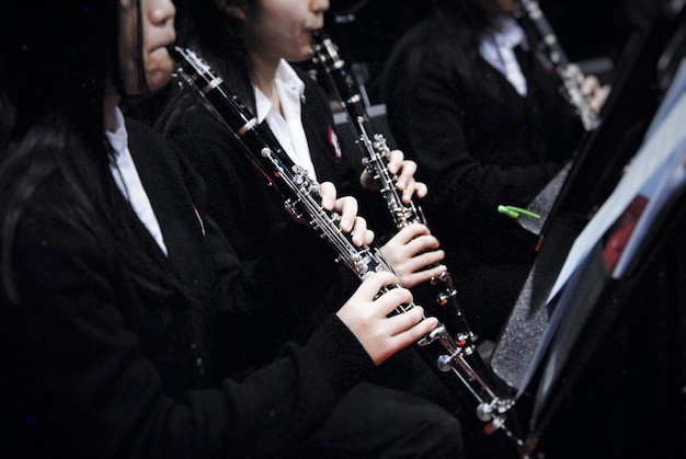 Photo midsection of women playing clarinet