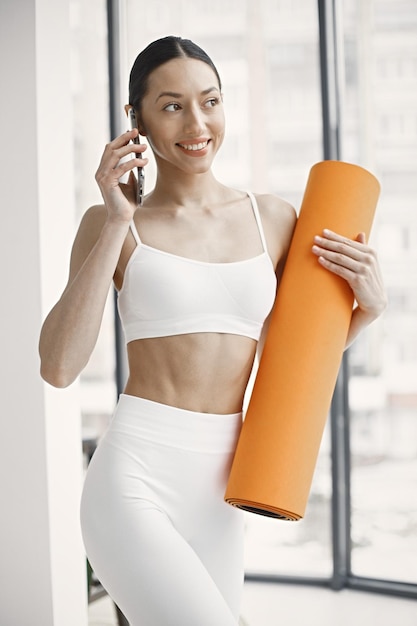 Midsection of young woman in white underwear posing in studio