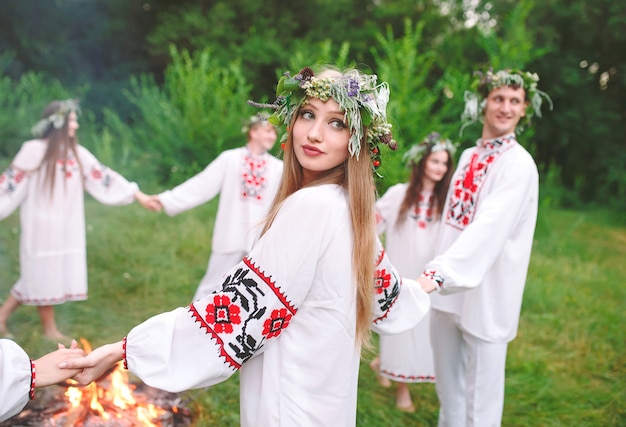 Midsummer. Young people in Slavic clothes revolve around a fire in the Midsummer. .