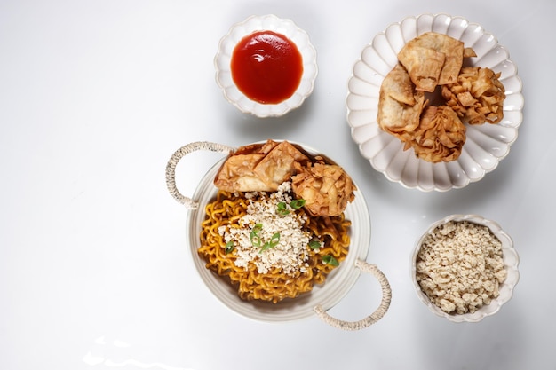 Mie Goreng ala Mie Gacoan is homemade fried noodle topping with chicken shraded and fried dumpling.