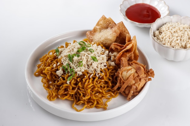 Mie Goreng ala Mie Gacoan is homemade fried noodle topping with chicken shraded and fried dumpling.