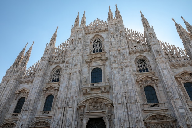 Milan, Italy - June 27, 2018: Closeup facade of Milan Cathedral (Duomo di Milano) is cathedral church of Milan. Dedicated to St Mary of Nativity, it is seat of the Archbishop of Milan