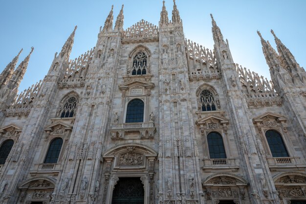 Milan, Italy - June 27, 2018: Panoramic view of exterior of Milan Cathedral (Duomo di Milano) is cathedral church of Milan. Dedicated to St Mary of Nativity, it is seat of the Archbishop of Milan