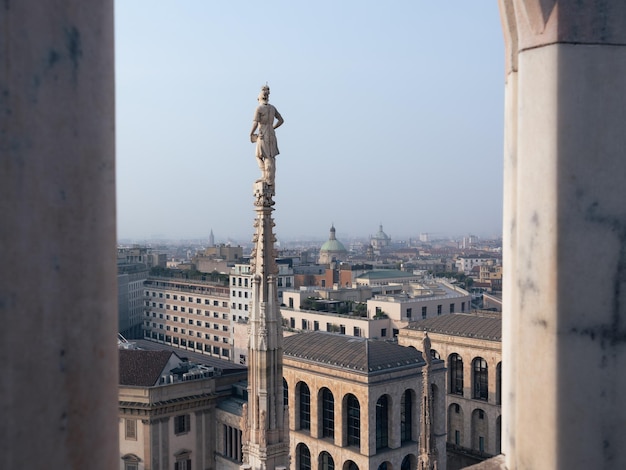 Milan rooftop view at sunrise with exquisite gothic architecture of Duomo catholic cathedral Italy