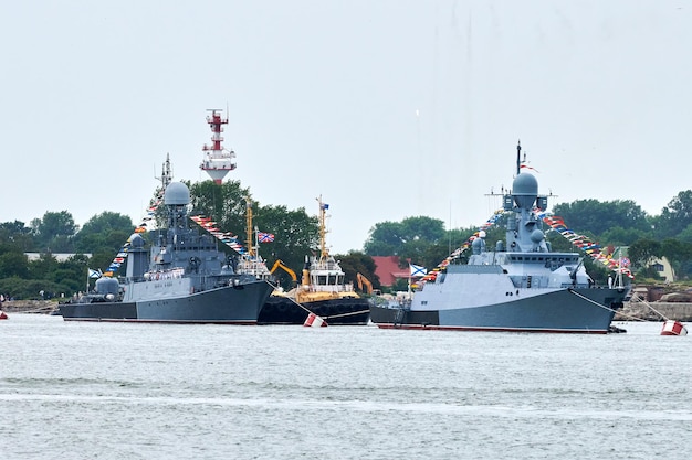 Military parade of Russian naval forces ships along coastline seafaring tradition of ships formation