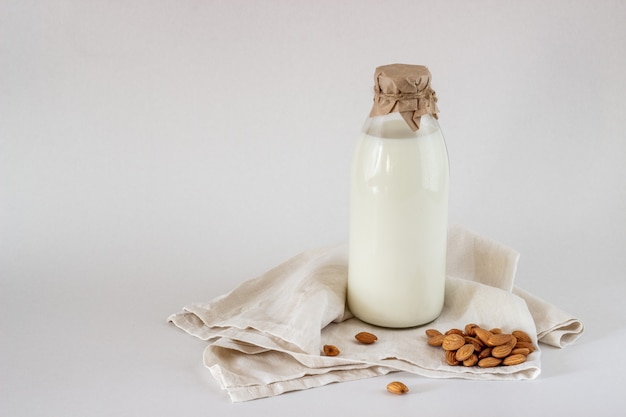 Milk and almonds on a white background