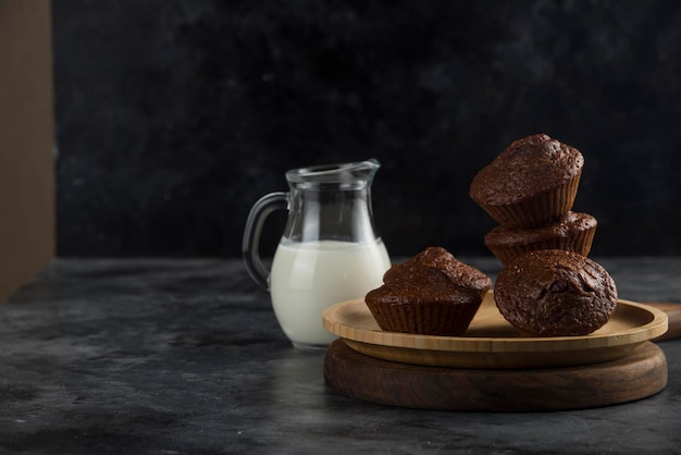 Milk and Brown Cookies on wooden cutting board