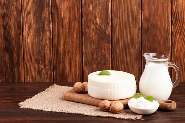 Milk and cheese on chopping board