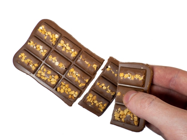 Milk chocolate bar with nuts on a white background