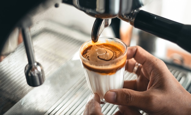 Milk coffee,Milk and coffee in a glass from the maker