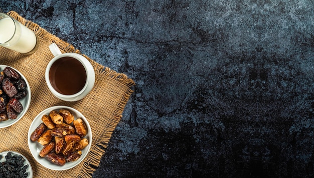 Milk dried dates fruit and apricot on dark background