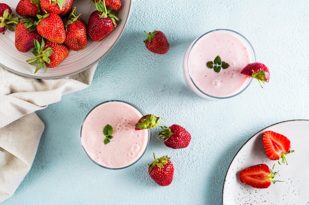 Milk smoothie with strawberries and mint in glasses on the table Healthy homemade food Top view