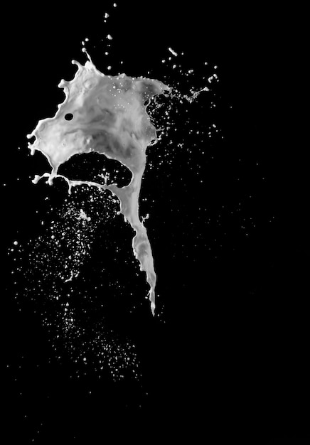 Milk splash against black background