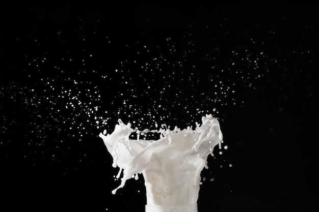 Milk or white liquid splash on dark background