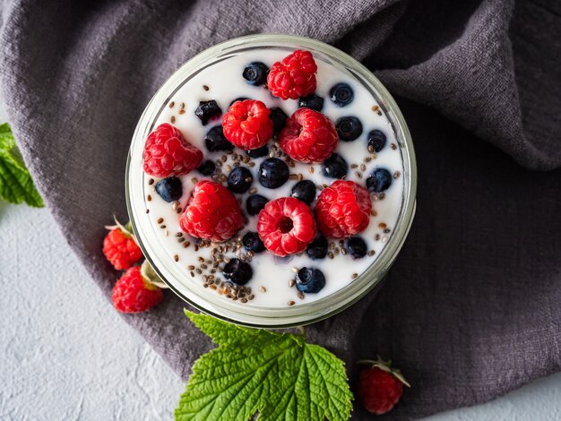 Milk yogurt with blueberries, raspberries, detox. Copy space.