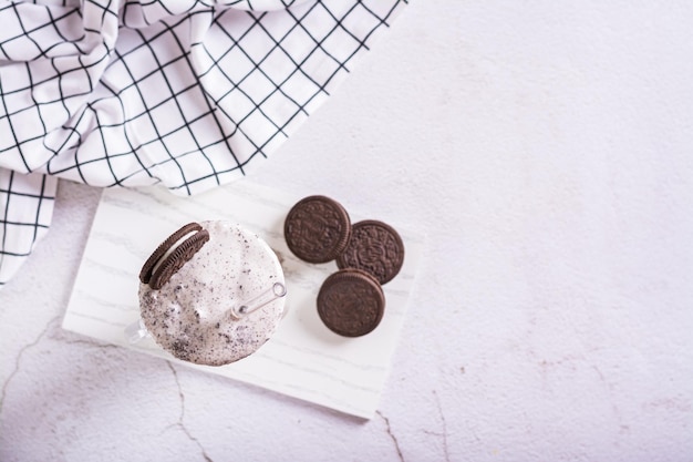 Milkshake of chocolate oreo cookies and ice cream in a glass with a straw top view