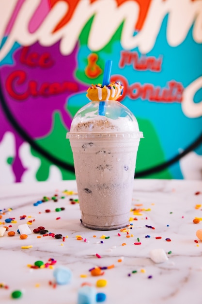 Milkshake sitting on a marble countertop with candy and marshmallows at a local business