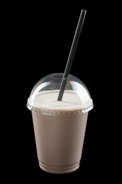 Milkshake with ice cream, juice and fruit syrup isolated onblack background