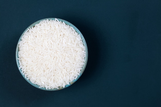 Milled rice in a green cup placed on the green board