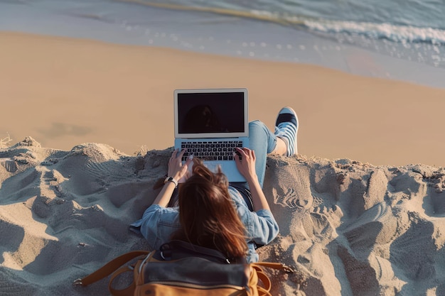 Photo millennial freelancer female using mockup laptop with empty screen blank and lying on the sand beach