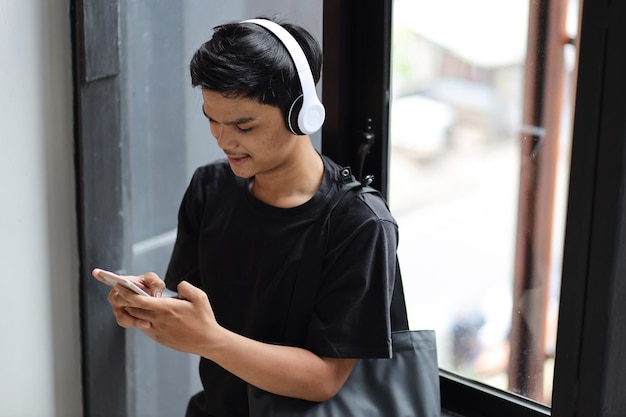 Millennial young man texting on mobile phone