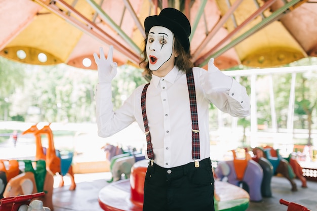 Mime posing in a carousel