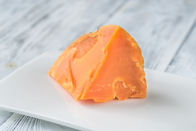 Mimolette cheese on white plate