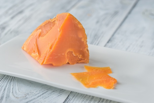 Mimolette cheese on white plate