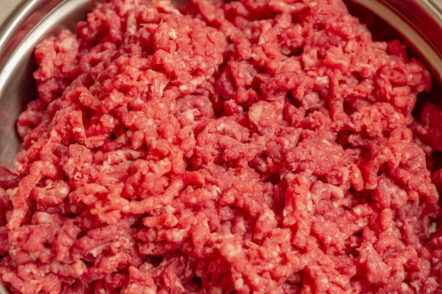 Minced beef close-up in a metal plate. Minced cutlets cooking for dinner. beef, grinder, raw, food, meat, cooking.