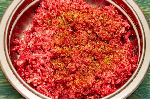 Minced beef close-up in a metal plate. Minced cutlets cooking for dinner. beef, grinder, raw, food, meat, cooking.