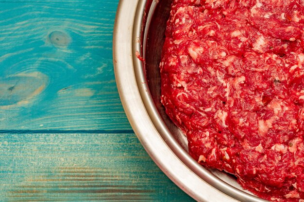 Minced beef close-up in a metal plate. Minced cutlets cooking for dinner. beef, grinder, raw, food, meat, cooking.