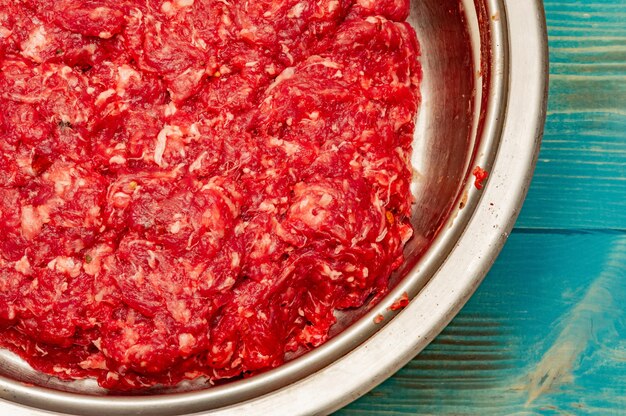 Minced beef close-up in a metal plate. Minced cutlets cooking for dinner. beef, grinder, raw, food, meat, cooking.