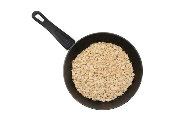 Minced meat in a frying pan, isolated on white background.