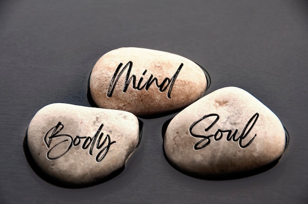 Mind Body and Soul words engraved on stones Healthy life concept