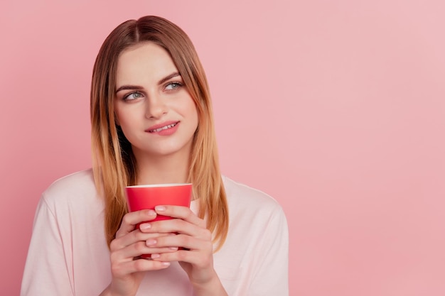 Minded curious lady hold cup drink coffee look empty space think ponder bite lip