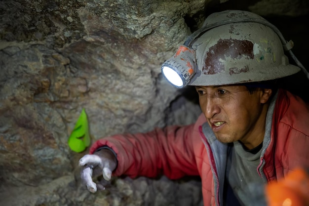 A miner in a helmet with a lantern is in the Potosi mine Bolivia