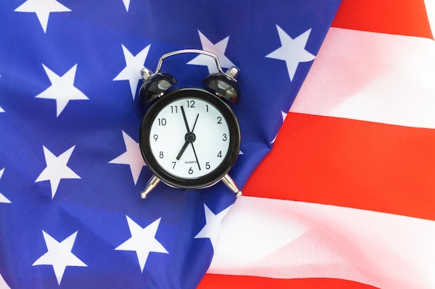 Mini alarm clock on American flag Journey to USA