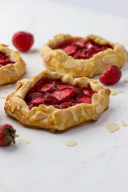 Mini biscuits with strawberries Small berry pies on a white background