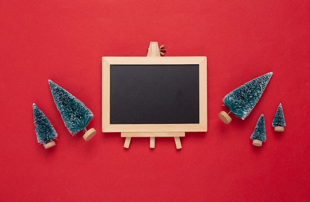 Mini blackboard with Christmas tree on red background Empty blank chalkboard with copy space New year Christmas still life