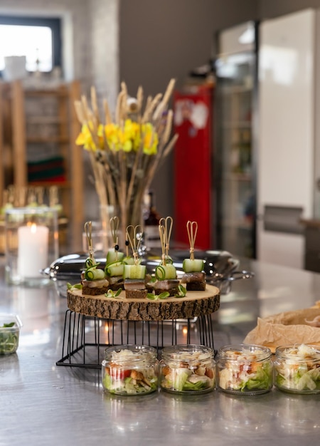 Mini canapes on rye bread with cucumber and herring Catering Buffet table for banquet event