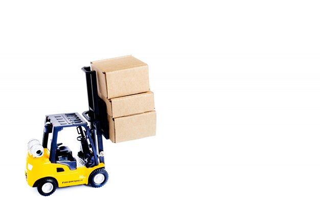 Photo mini forklift truck load cardboard boxes isolated on white background. logistics and transportation management ideas and industry business commercial concept.