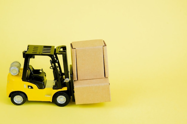 Photo mini forklift truck load cardboard boxes. logistics and transportation management ideas and industry business commercial concept.